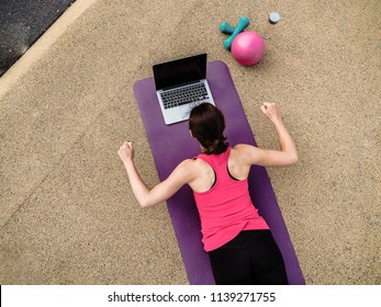 Groggy Woman Sleeping Infront Of A Laptop On A Yoga Mat After  Doing A Fitness Workout From Bird View