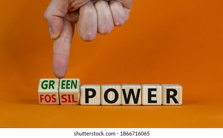 Grom fossil to green power. Male hand turns cubes and changes the words 'fossil power' to 'green power'. Beautiful orange background. Business and green power concept. Copy space. - Shutterstock ID 1866716065