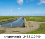 Groningen, Netherlands - August 9th 2023: Small sailing harbour in the marshland in the ems river mouth region