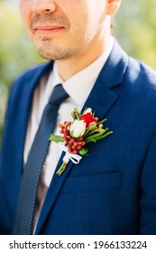 Groom In A Blue Jacket, Tie And White Shirt With A Boutonniere On The Lapel