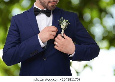 Groom with boutonniere outdoors, closeup. Wedding accessory - Powered by Shutterstock