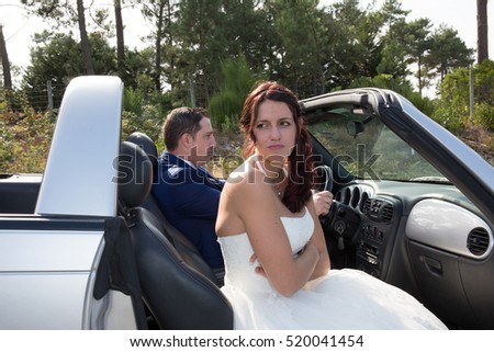 The groom and the bride in a convertible car