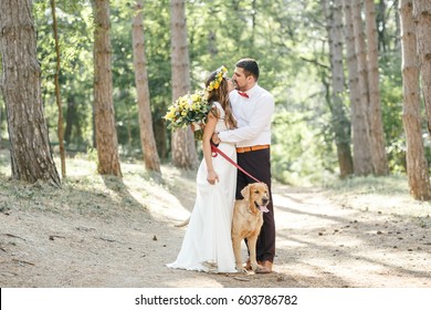 groom with the bride and the dog