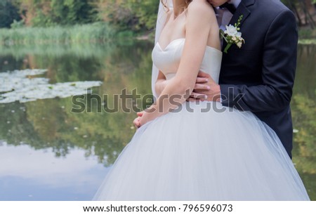 groom with the bride near the lake