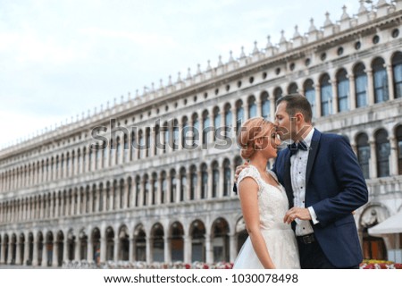 groom and bride posing in the square of Venice after wedding