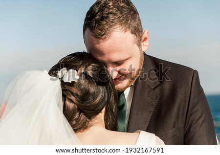groom with the bride at the sea. meeting of the bride and groom on the pier near the sea. wedding couple. groom with a red beard. the bride goes to the groom