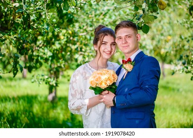 Groom In A Bright Blue Suit And Red Bow Tie On A Walk In A Summer Park