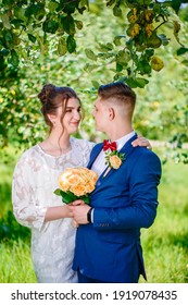 Groom In A Bright Blue Suit And Red Bow Tie On A Walk In A Summer Park