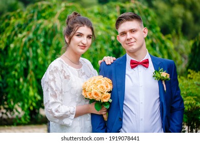 Groom In A Bright Blue Suit And Red Bow Tie On A Walk In A Summer Park