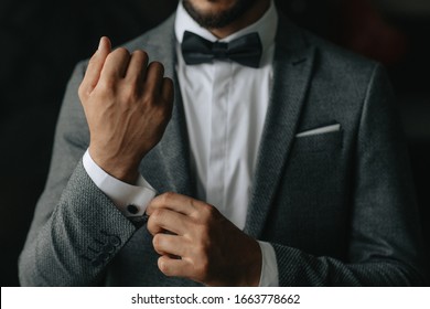 the groom fastens the cufflinks at the groom's morning gatherings - Shutterstock ID 1663778662