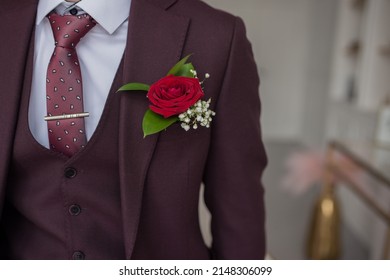 groom with flower, red rose boutonniere in jacket. High quality photo