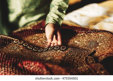 Groom In Green Shirt Touches His Red Sherwani