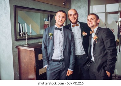 Groom With Groomsman In Restaurant Stairs. 