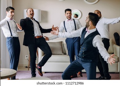 Groom And Groomsmen Have Fun Dancing In The Hotel Room