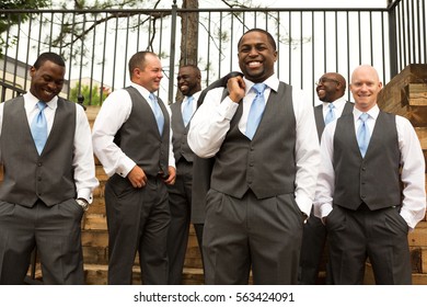 Groom and groomsmen posing for wedding pictures - Powered by Shutterstock