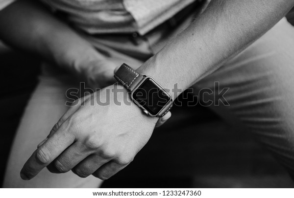 the\
groom - a handsome man - puts a watch on his\
hand