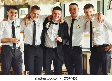 Groom and his friends pose in a restaurant