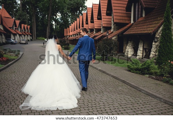 the groom and his wonderful woman walking in a\
beautiful place
