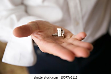 Groom Holding Cuff Links In His Hand