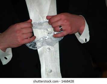 Groom Holding Garter At Wedding