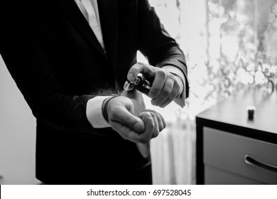 The Groom Is Holding Perfume. Groom Have A Final Preparation For Wedding - Man Holing A Parfume Bottle And Spraying Fragrance On Hand