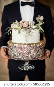 Groom Holding Winter Wedding Cake