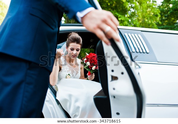 Groom open\
door of limousine and take hand to\
bride