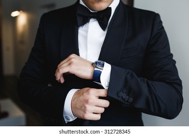 the groom puts on a watch - Shutterstock ID 312728345