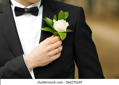 Groom In A Suit Holding Buttonhole