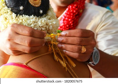 Groom tie a Thali/Tali knot to the Bride to take care of her for the entire life.Traditional Kerala Hindu Wedding Knot popularly known as Thali/Tali.It is a union of two individuals as spouses.