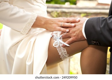 groom is touching her very sexy garter