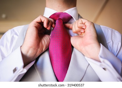 Groom Tying Wedding Cravat