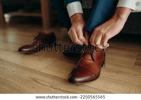 Groom is wearing his brown shoes for wedding