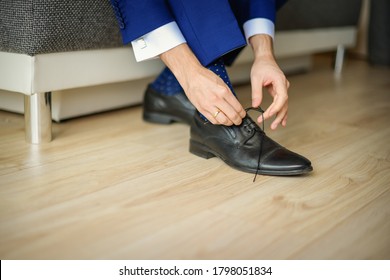 Groom Is Wearing Shoes In Blue Wedding Clothes Indoors. The Businessman Wears Shoes