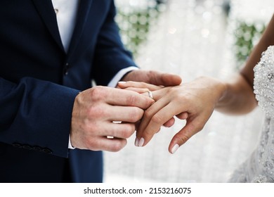 The Groom Wears A Ring To The Bride At The Wedding Ceremony