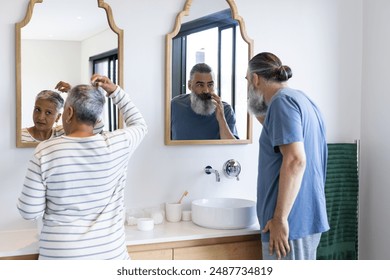 Grooming in bathroom, senior couple standing in front of mirrors. Personal care, togetherness, hygiene, routine, lifestyle, daily - Powered by Shutterstock