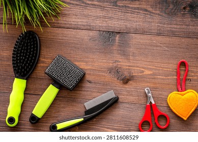 grooming tools for training pet and brushes on wooden desk background top view mock-up