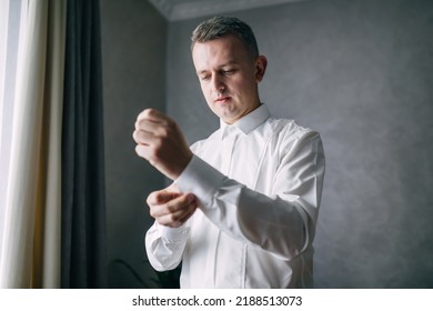 Grooms Morning Preparation. Handsome Man Getting Dressed And Preparing For The Wedding