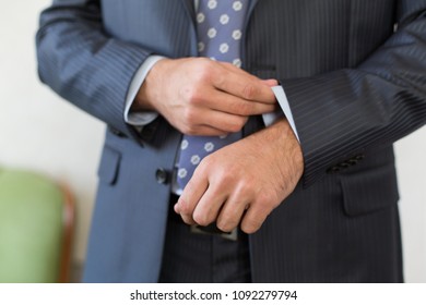 Groom's Morning. Wedding Preparing. Man In Blue Shirt Putting On Cufflinks. Business Dress Code