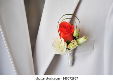 groom's red and white rose boutonniere - Powered by Shutterstock