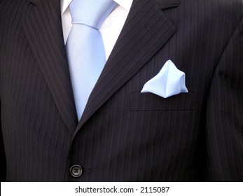 Groom's Torso With Blue Tie, Blue Handkerchief And Black Suit.