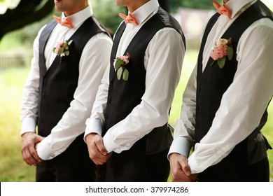 Groomsmen Standing On The Wedding Ceremony Outdoors