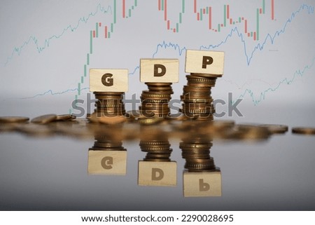 Gross domestic product concept. GDP word written on wooden bricks on stack coins. High quality photo [[stock_photo]] © 