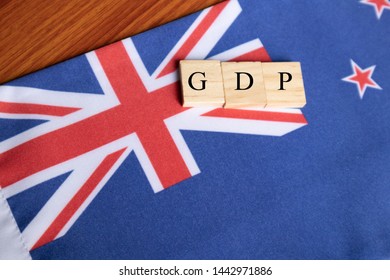 Gross Domestic Product Or GDP Of Australia In Wooden Block Letters On Australian Flag