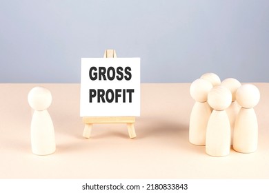 GROSS PROFIT text on a easel with wooden figure, meeting concept
