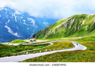 The Grossglockner High Alpine Road (in German Großglockner-Hochalpenstraße)  is the highest surfaced mountain pass road in Austria. Summer with  blue skyes green mountains and street for wallpaper.