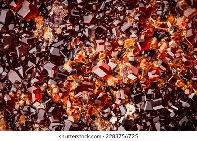 grossular (red garnet) cluster. macro detail texture background. close-up raw rough unpolished semi-precious gemstone