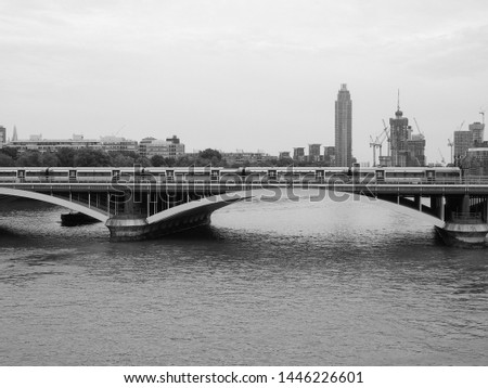 Grosvenor Bridge (aka Victoria Railway Bridge) crossing River Thames in London, UK in black and white