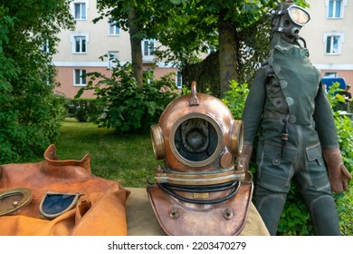 A Grotesque Diving Suit For Deep-sea Exploration And Adventure. Antique Diving Suit Made Of Metal And Leather At The Exhibition Of Antiques.