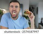 Grotesque looking adult eating without manners 